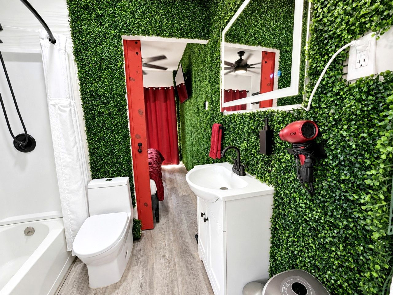 A bathroom with a white toilet, a sink, and a shower area.
