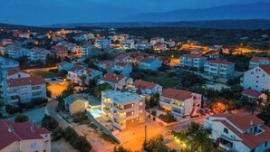 A residential area with multi-story buildings, roads, and a mountainous backdrop. - Star house 1 (Novalja)
