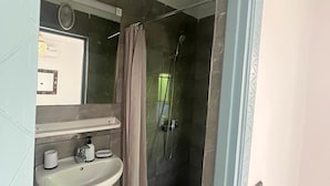 A bathroom with a white sink, a mirror, and a shower area with a glass door. - 3-bedroom riad in amazing Marrakesh with fitness room, AC for family & friends (Marrakesh)