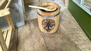 A wooden interior with a wooden barrel, a wooden spoon, and a stove.