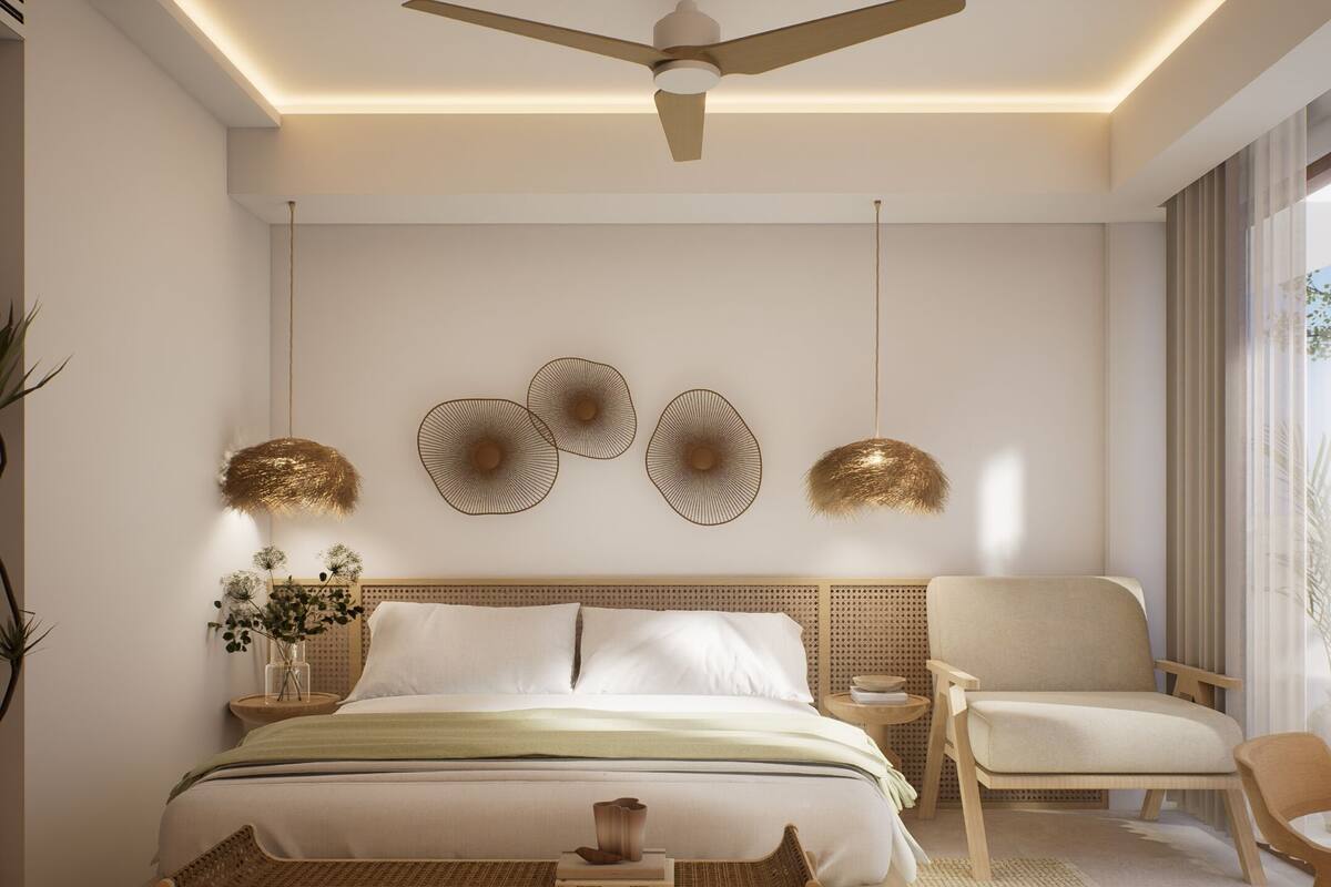A modern bedroom with a bed, a chair, a bedside table, and decorative wall art.