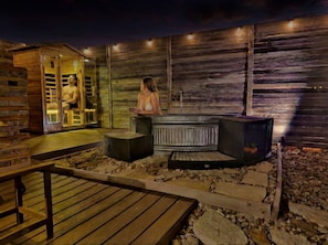 A sauna area with wooden walls, benches, and a stone floor. - Impressive Intimate Tiny Cabin with Lofted Interior and Outdoor Shower in Texas (Wimberley)