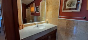 A bathroom with a white sink, a large mirror, and a framed picture on the wall. - Vacation Villa 'Adais' with Private Pool, Wi-Fi and Air Conditioning (Playa Blanca)