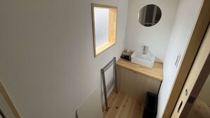A compact bathroom with a window, a sink, and a mirror. - Old-style inn Hinataya　Double room (中津川市)