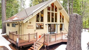 A wooden cabin with a porch, large windows, and a sign reading '3246 KENSHAW PINECONE COTTAGE.' - Pinecone Cottage in Dorrington, CA (Dorrington)