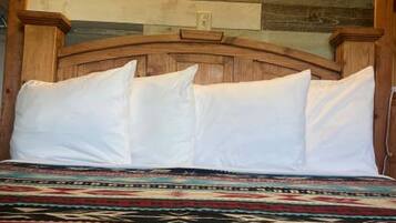 A bed with a wooden headboard and a patterned bedspread.