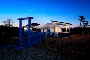A dome structure with a blue entrance gate labeled 'INCREED-DOME' and a covered seating area with lights.