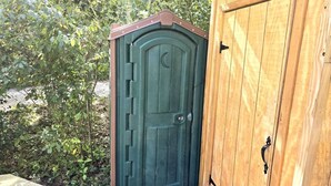 A wooden door with a crescent moon design, a metal handle, and a wooden frame. - Geodome on Creek, Great Getaway, WIFI & Hot Shower near Boone, NC (Purlear)