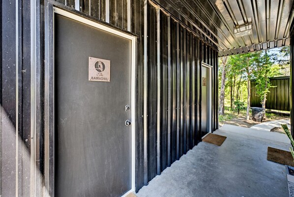 A metal-framed building with a closed door labeled 'The Barnowl.'