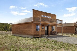 A wooden building with a sign reading 'Mercantile' and a balcony. - Stunning Old West Cabin with Fireplace in Island Park, Idaho (Island Park)
