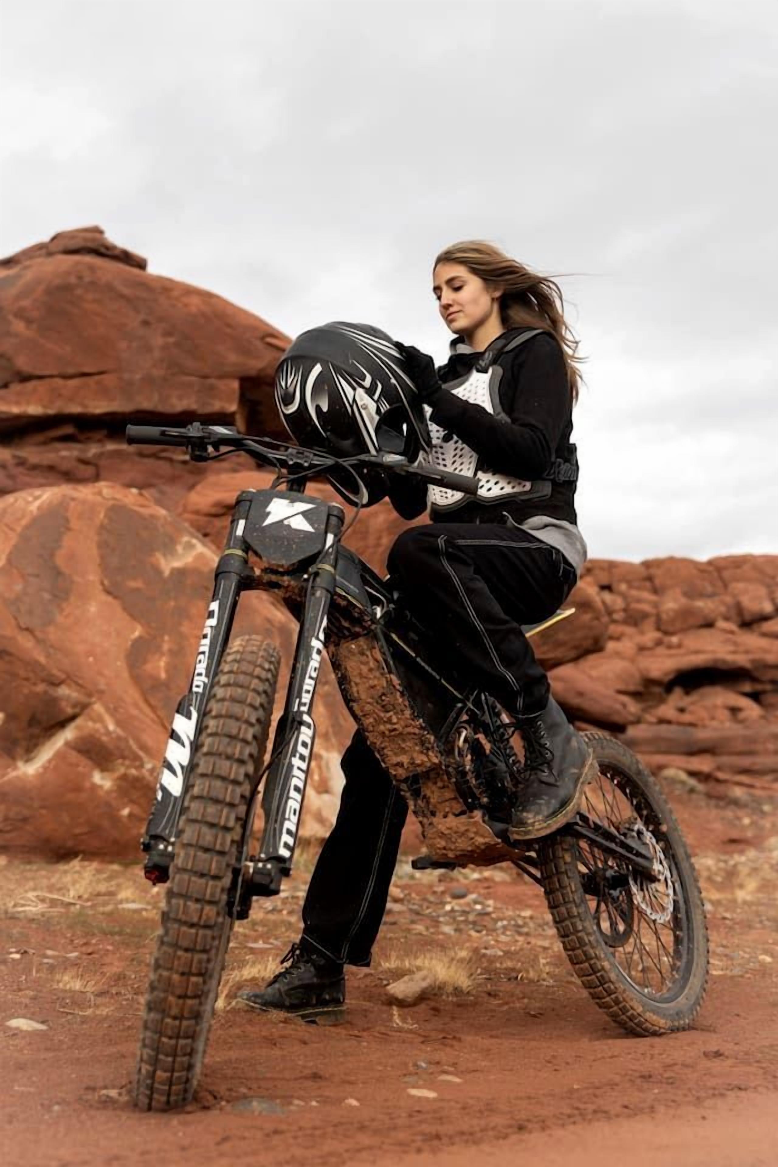 A person on a dirt bike in a rugged outdoor setting.