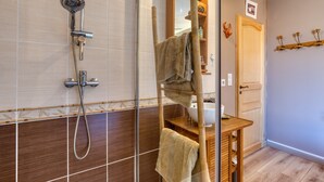 A bathroom with a shower, a towel rack, a wooden vanity, and a mirror. - Guest Room "La Petite Camargue" with Private Pool, Shared Terrace and Wi-Fi (Vauvert)