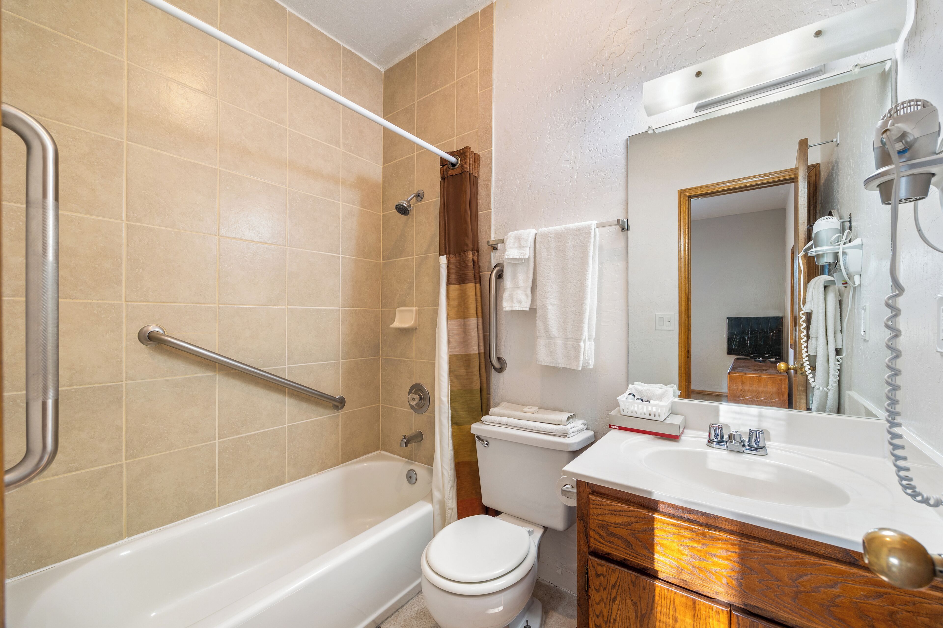 A bathroom with a bathtub, toilet, and sink.
