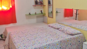 A bedroom with two beds, a red curtain, a cityscape picture, and a small shelf with figurines. - Welcome to Casa Trajano in Olinda! Here, you will find comfort! (Olinda)