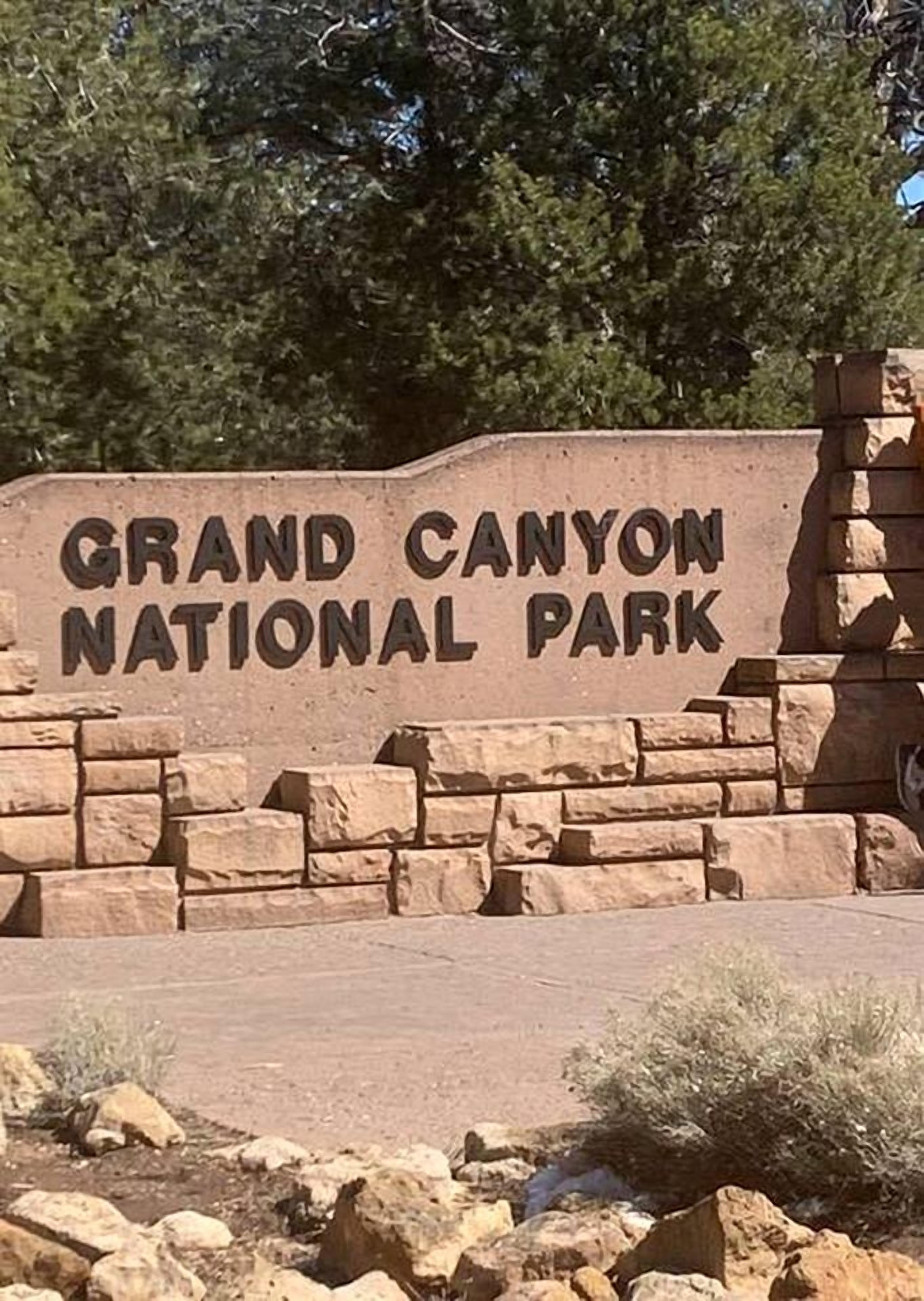 A stone sign with the text 'Grand Canyon National Park'.