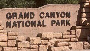 A stone sign with the text 'Grand Canyon National Park'.
