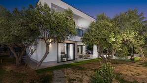 A modern two-story house with a patio, surrounded by olive trees. - Villa Karla with pool&sea view by Villas Guide (Banjol)
