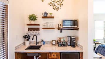 Fridge, microwave, coffee/tea maker, cookware/dishes/utensils