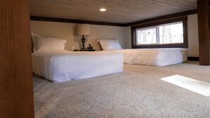 A bedroom with two beds, a window, and a ceiling light. - Picturesque Tiny Cottage with Cozy Indoor and Outdoor in Tennessee (Monteagle)