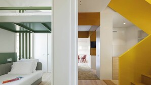 A modern hotel room with a bunk bed, a desk, and a dining area in the background. - A'Mar - Room C (Póvoa de Varzim)