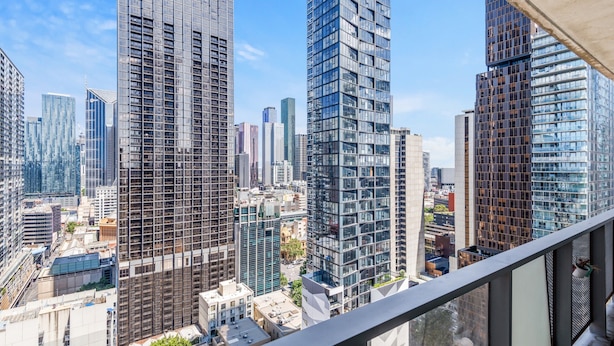 A high-rise building with a modern architectural design, featuring a mix of glass and steel facades. - Modern City Convenience With Great Amenities (Melbourne)
