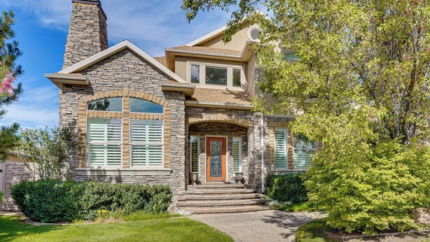 A two-story house with a stone facade, a front porch, and a well-maintained lawn. - Upscale Group Getaway in Orem w/ Private Hot Tub (Orem)