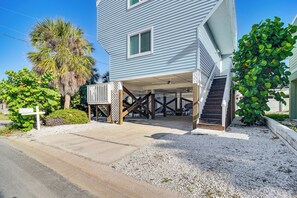 A two-story house with a covered porch and a staircase leading to the second floor. - 1 Block to Sunset Beach: Dog-friendly Family Home (Treasure Island)