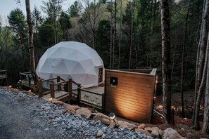 A geodesic dome tent with a wooden deck and a small cabin-like structure with a number 3 sign. - Georgia's Trendy Family Escape: Dome with Private Hot Tub in Cherry Log (Cherry Log)