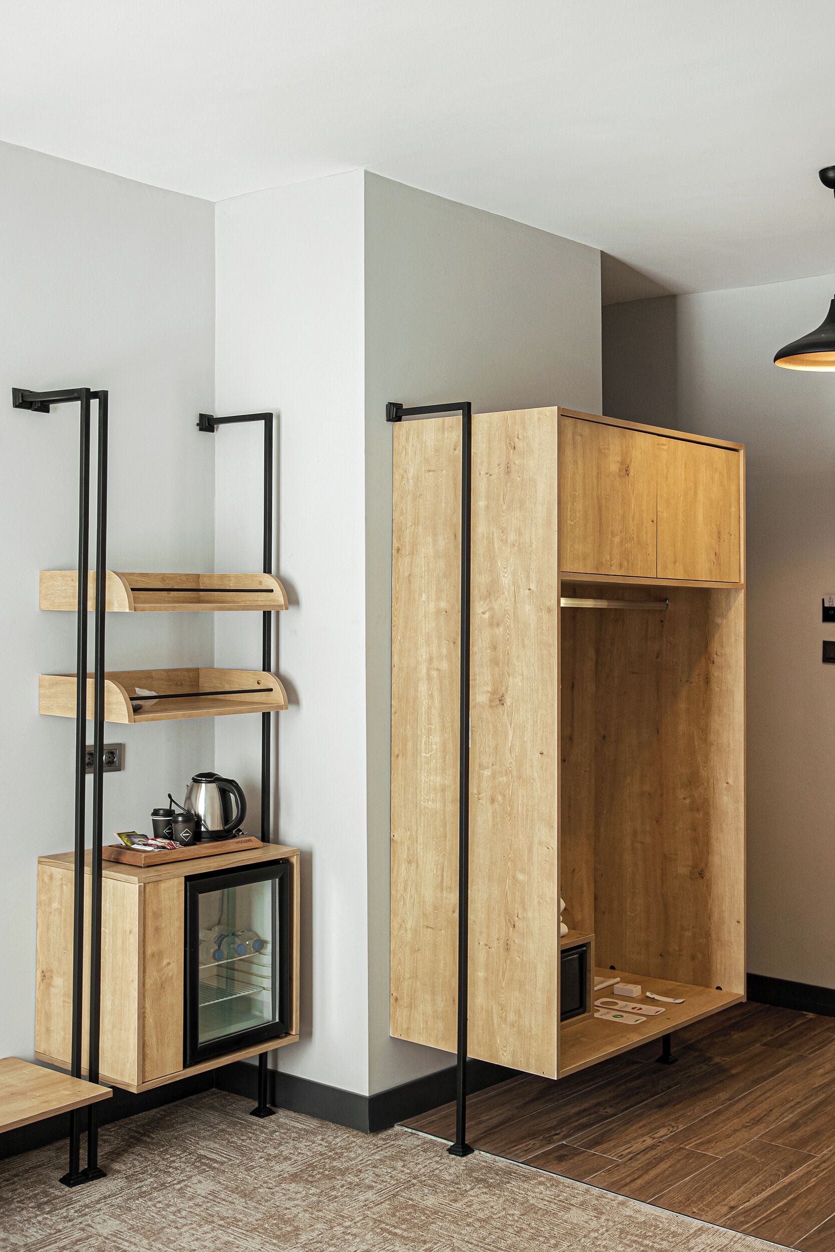 A modern interior with a wooden cabinet, a small refrigerator, and a shelf unit.