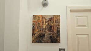 A wall-mounted light fixture above a painting of a bridge. - Ground Floor 1BDR Garden Flat South Croydon (Greater London)