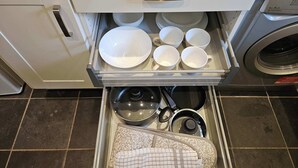 A kitchen with a drawer containing dishes, a kettle, and a pot. - Ground Floor 1BDR Garden Flat South Croydon (Greater London)