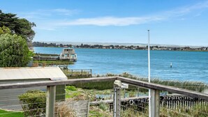 A waterfront property with a dock, a small building, and a grassy area. - Riverside Retreat - Waterfront - Hindmarsh Island (Hindmarsh Island)