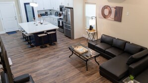 A modern kitchen with white cabinets, a stainless steel refrigerator, and a coffee maker. - 200 Steps To Beach Private Pool 2 Big Levels 3 Bedroom Apts (South Padre Island)