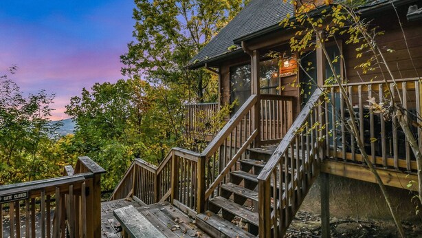 A wooden staircase leading to a porch with a "GATE CLOSED" sign. - Smoky Mountain Bliss 2 Bedroom Cabin (Gatlinburg)