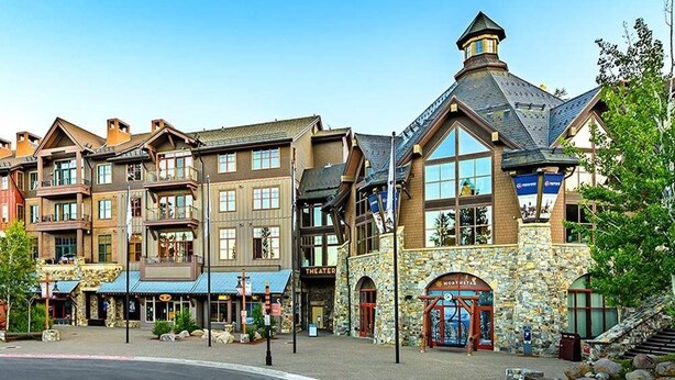 A row of multi-story buildings with a theater, a restaurant, and a spa. - Indian Hills 6021 2 Bedroom Townhouse (Truckee)