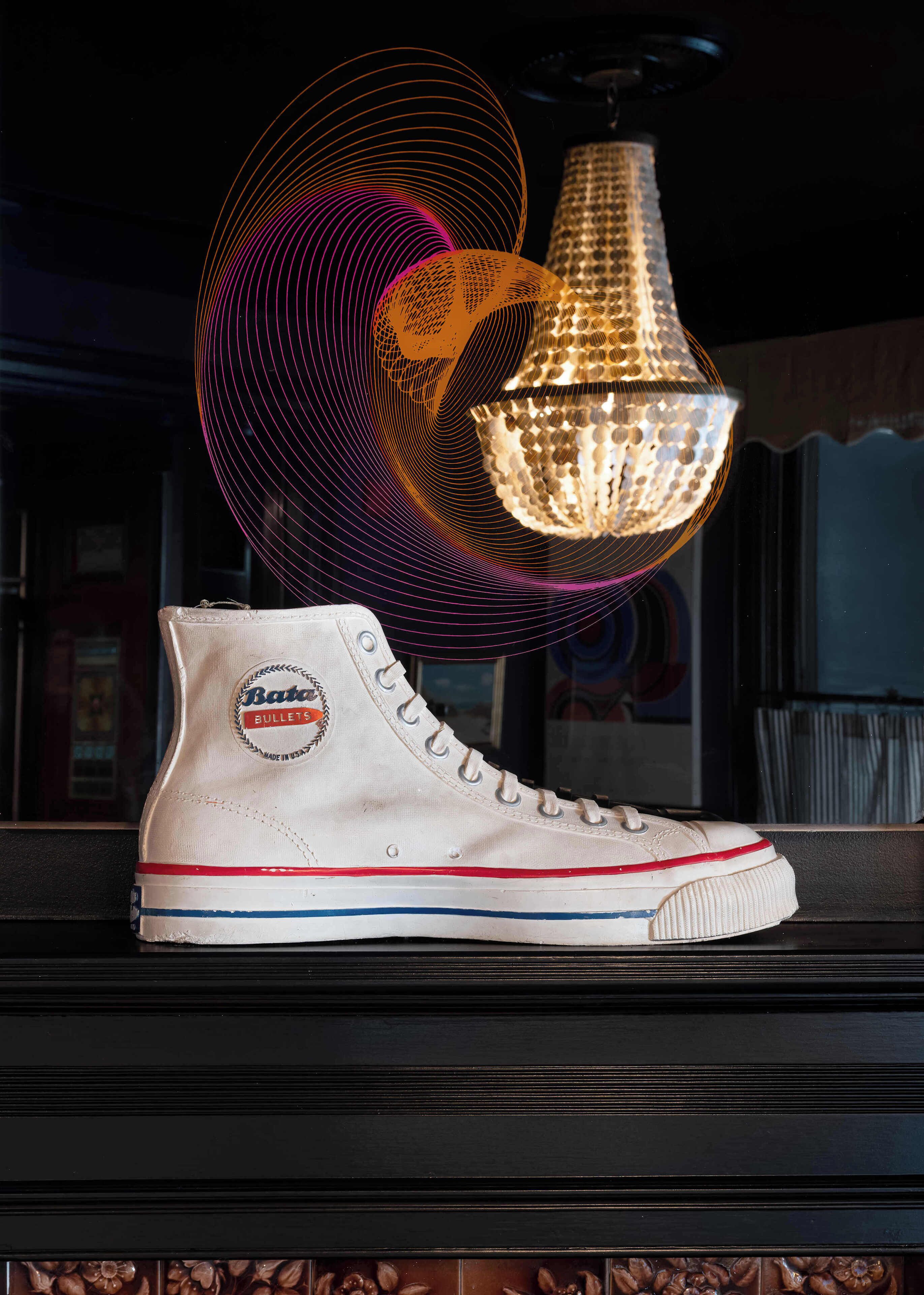 A high-top sneaker with a 'Bata Bullets' logo on a dark surface.