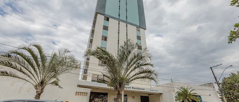 A tall building with a modern design, featuring a mix of glass and concrete.
