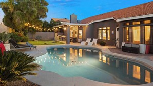 A swimming pool with lounge chairs, a covered patio, and a well-maintained garden. - LUX Modern Escape: Pool, Putt, Kierland Commons (Scottsdale)