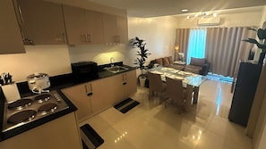 Fridge, microwave, cookware/dishes/utensils, dining tables - Spacious 2-Bedroom at Sea Residences, Pasay — just steps from SM Mall of Asia! (Pasay City)