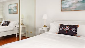A hotel room with a large bed, a nightstand, a lamp, and a painting on the wall. - Green Views & Great Location: Inner-city 1-bed (Sydney)