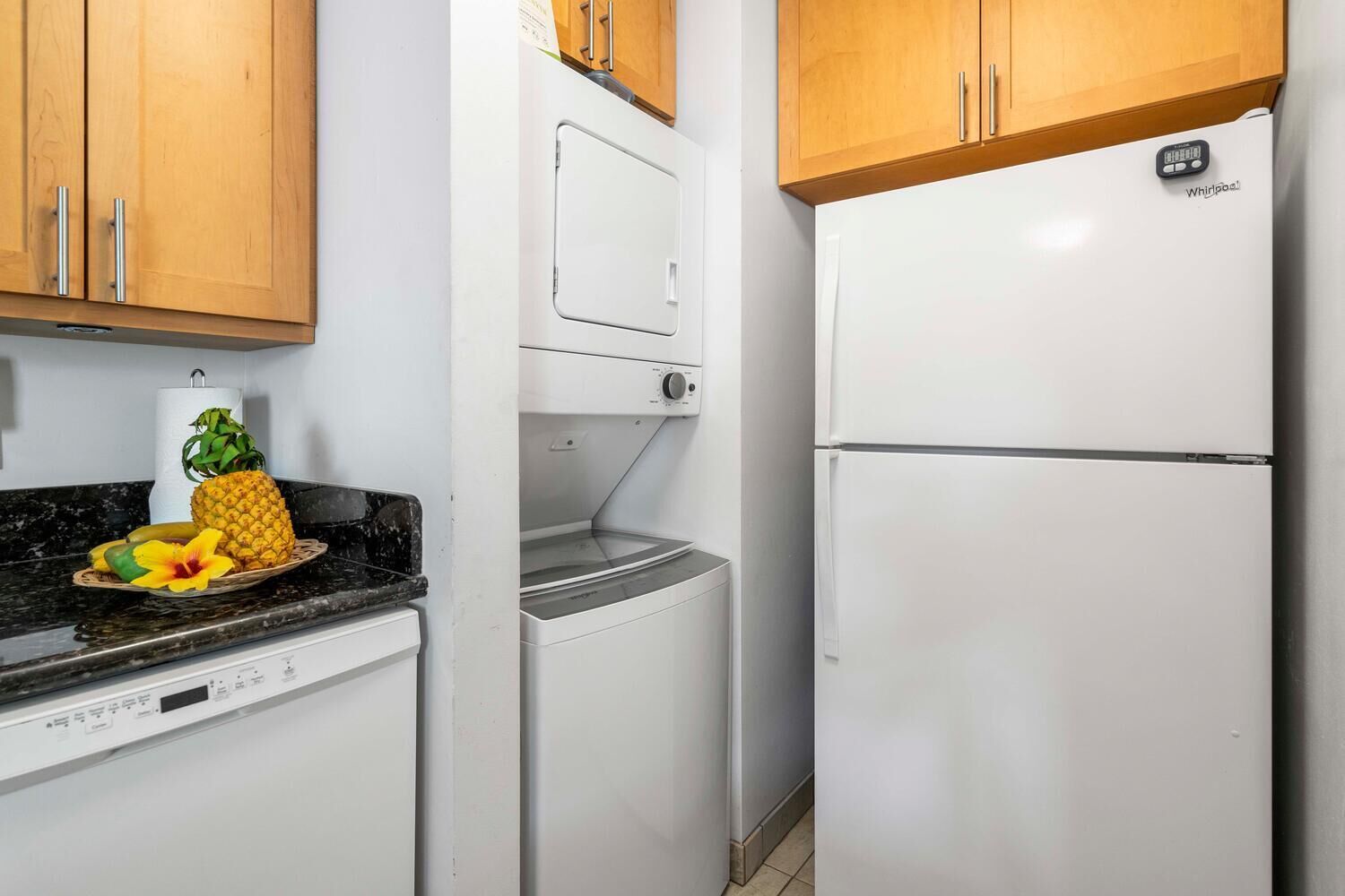 A compact kitchen with a dishwasher, a microwave, and a refrigerator.