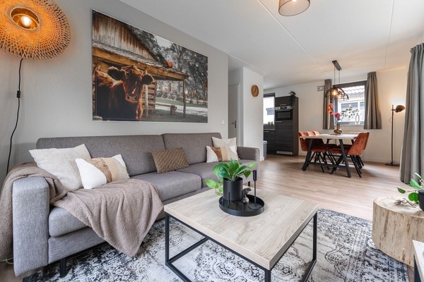 Stylish living area with SMART TV and large sofa — perfect for relaxing after swimming, biking, or hiking in the park.