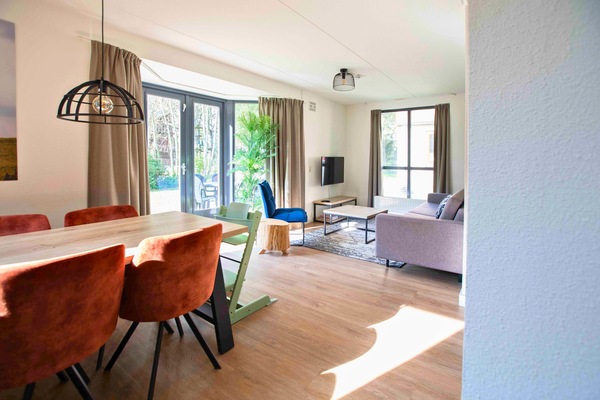 Spacious living room with natural light and garden view.