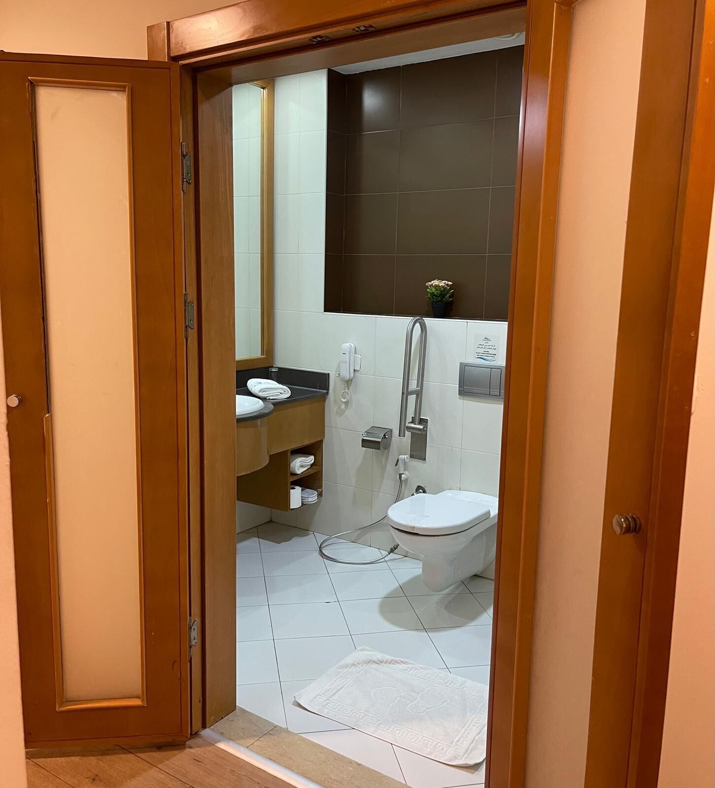A bathroom with a toilet, sink, and shower.