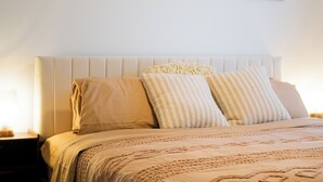A bedroom with a bed, pillows, and three wall-mounted artworks. - The Emerald Escape 2BR/2BA King Suite (Hermiston)