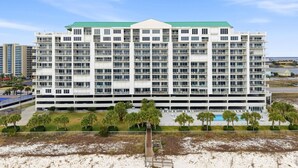 Un hotel a più piani con tetto verde, numerosi balconi e un garage.