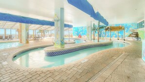 An indoor swimming pool with a tiled floor, a central fountain, and a mural on the walls. - The Caribbean Resort and Villas #327 (Myrtle Beach)
