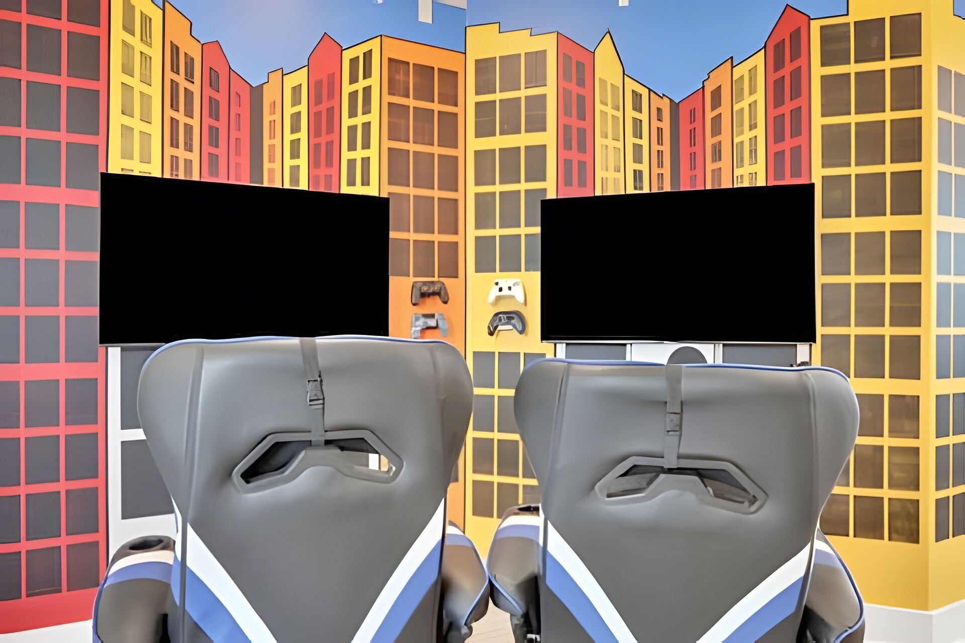 A 3D animated cityscape with colorful buildings and two gray, futuristic chairs facing each other.