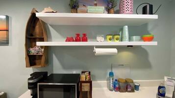 Fridge, microwave, coffee/tea maker, cookware/dishes/utensils