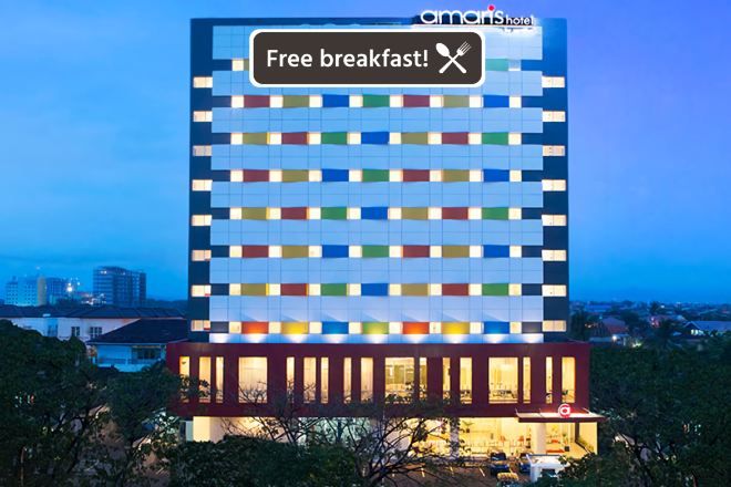 A multi-story hotel with a distinctive facade featuring a grid of illuminated panels.